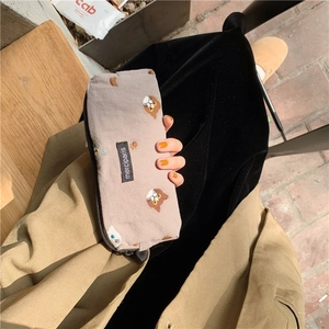 Close-up of Japanese style canvas pencil case featuring colorful cat embroidery and zip