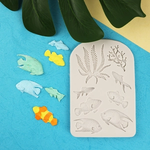 Gray silicone ocean mold featuring fish, coral, and seaweed shapes with colorful resin pieces