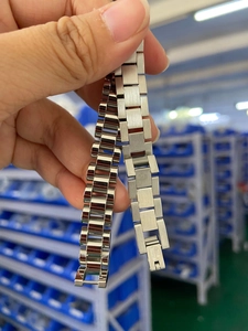 Close-up of stainless steel watchband bracelet showing polished and brushed finish details