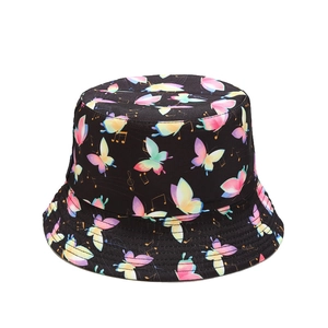 Reversible bucket hat with colorful butterfly and music note prints on black fabric