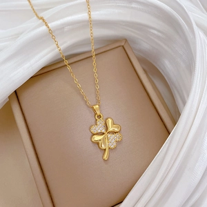 Gold-plated four-leaf clover necklace with sparkling cubic zirconia in a jewelry box