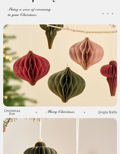 Close-up of honeycomb paper Christmas balls in vintage colors hanging on a branch