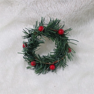 Mini Christmas wreath with red berries and green pine needles on white faux fur