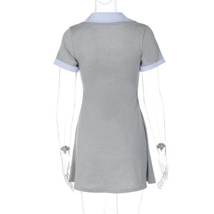 Detail view of the back of a grey knit dress featuring blue and white striped contrast cuffs