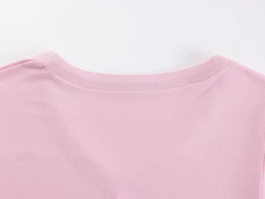 Close-up of the delicate pink V-neck stitching and ribbed knit texture on the cotton t-shirt
