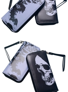 Detail of vintage skull and bat pattern long wallets with wrist straps and zipper closure