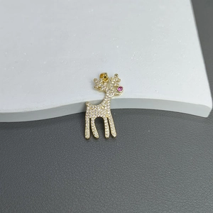 Close-up of a gold deer pendant with micro-pave crystals and a pink nose detail