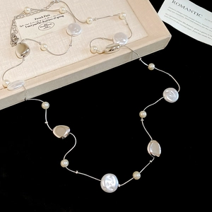 Detailed view of elegant silver pearl necklace with adjustable lobster clasp and extension chain