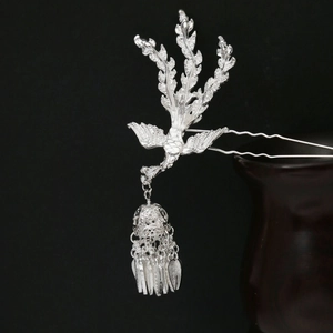 Detailed silver phoenix hair stick with intricate tassel charms and hollow filigree beads