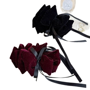 Elegant velvet bow hair clips set in black and burgundy with subtle glitter finish