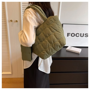 Olive green quilted tote bag showing large capacity and comfortable shoulder strap
