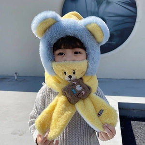 Detail of yellow and blue fuzzy winter hat scarf combo with cute 3D bear decoration