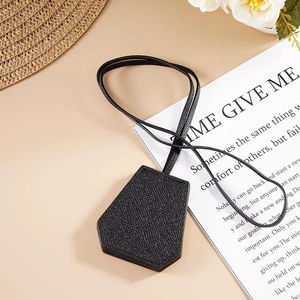 Classic black leather magnetic hat clip for outdoors shown on an elegant white card