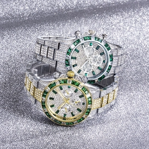 Macro detail of luxury iced-out chronograph watches with green baguette gemstone bezels