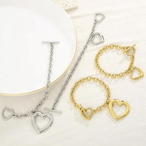 Flat lay of gold and silver heart pendant bracelets with toggle T-bar closure