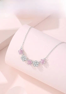 Close-up of five-petal S925 silver necklace with pink and white zircon floral pendants