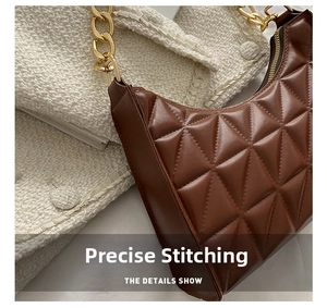 Close-up of brown quilted hobo bag with gold chain strap and detailed stitching