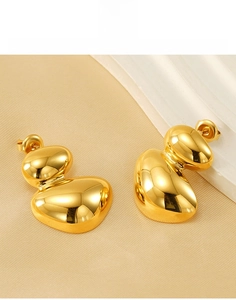 Close-up of golden irregular double-layered geometric earrings made of durable titanium steel