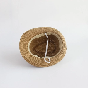 Kids woven straw sun hat in light brown with white elastic chin strap and sweatband