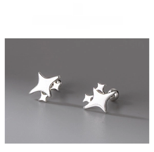 Macro detail of S999 sterling silver star-shaped stud earrings with screw-back design