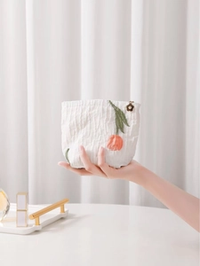 Elegant white tulip embroidered cosmetic bag with textured fabric and floral charm zip