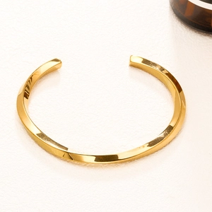 Polished gold Mobius twist open bangle in stainless steel for men and women