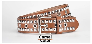 Close-up of camel leather belt with double silver pyramid studs and eyelet detailing