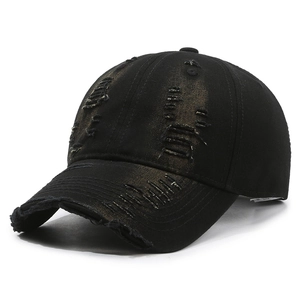 Vintage distressed black baseball cap with ripped denim details and retro street style