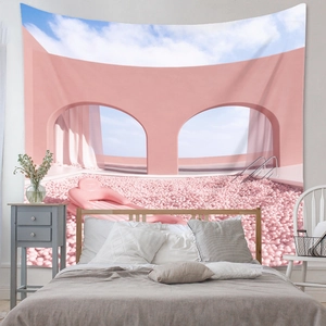 Detail view of Bohemian wall tapestry featuring a surreal pink architecture and sky scene