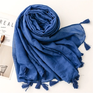 Close-up of deep blue scarf with subtle shimmer details and matching fringe edges