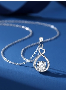 Macro shot of S925 silver heart necklace featuring infinity symbol and cubic zirconia