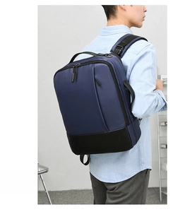 Male model wearing dark blue and black business laptop backpack showing back and side profile