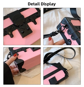Detail of pink vintage box bag featuring black metal lock, rivets and reinforced corners