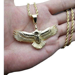 Polished gold-plated eagle pendant necklace with detailed feathers and twisted chain