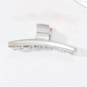 Minimalist silver metal shark hair claw clip with a glossy finish for elegant updos