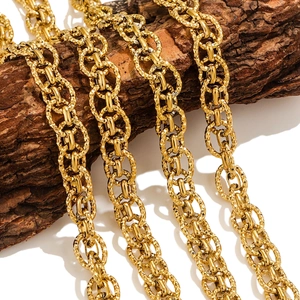 Polished gold multi-layer O-chain necklace displayed on a textured tree bark background