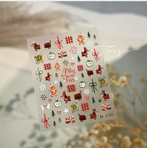 Detailed view of Christmas nail stickers featuring dachshunds, gingerbread men and bows