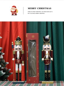 Close-up of two Christmas wood nutcrackers in a festive gift box with holiday backdrop