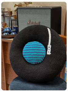Detail of soft vinyl record plush pillow featuring textured teddy fleece and retro styling