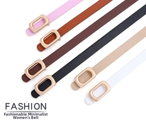 Detail of six colorful thin PU leather belts with elegant golden oval metal buckles