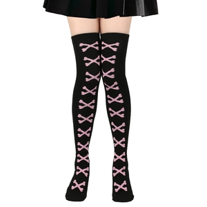 Detail of black over-knee high socks with pink crossbone patterns for Halloween outfit