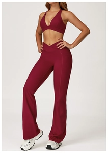 Detail of dark burgundy yoga set featuring deep V-neck top and flared high-waist pants