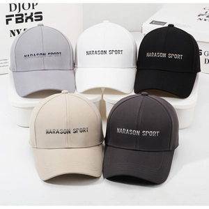Detail of five cotton baseball caps with Narason Sport embroidery in neutral tones