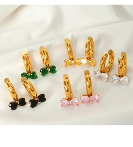 Detailed set of five gold hoop earrings featuring colorful bow-shaped crystal pendants