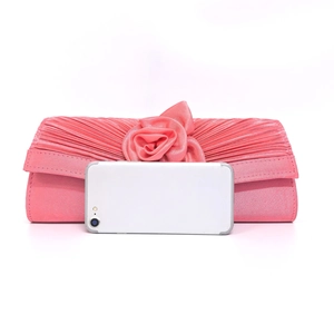 Pink satin evening clutch with handmade rose flower detail and smartphone size reference