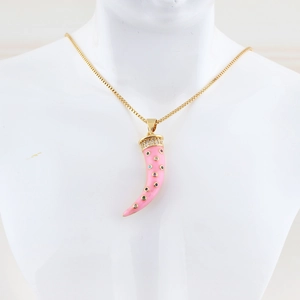 Detail of a pink horn pendant necklace with colorful zircons and golden chain
