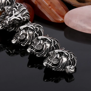 Detailed close-up of vintage lion head stainless steel charms with ornate engravings