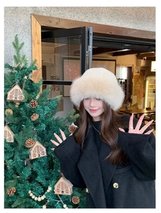 Close-up of off-white faux fur bucket hat with plush texture for winter warmth
