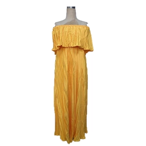 Detail of yellow off-shoulder chiffon maxi dress with intricate pleated texture fabric