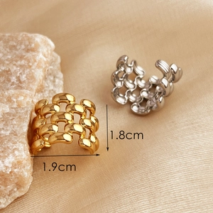 Gold and silver hollow chain ear cuffs with dimensions shown on beige fabric background